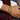 Close-up of a wrist wearing two beaded bracelets with a blurred background