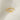 Gold bow-shaped ring on a light fabric background